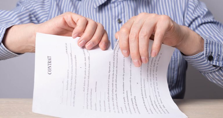 A man in a shirt ripping up a letter
